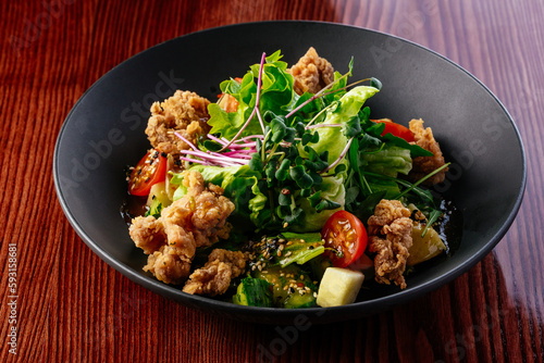 warm salad with chicken, vegetables and herbs. restaurant menu