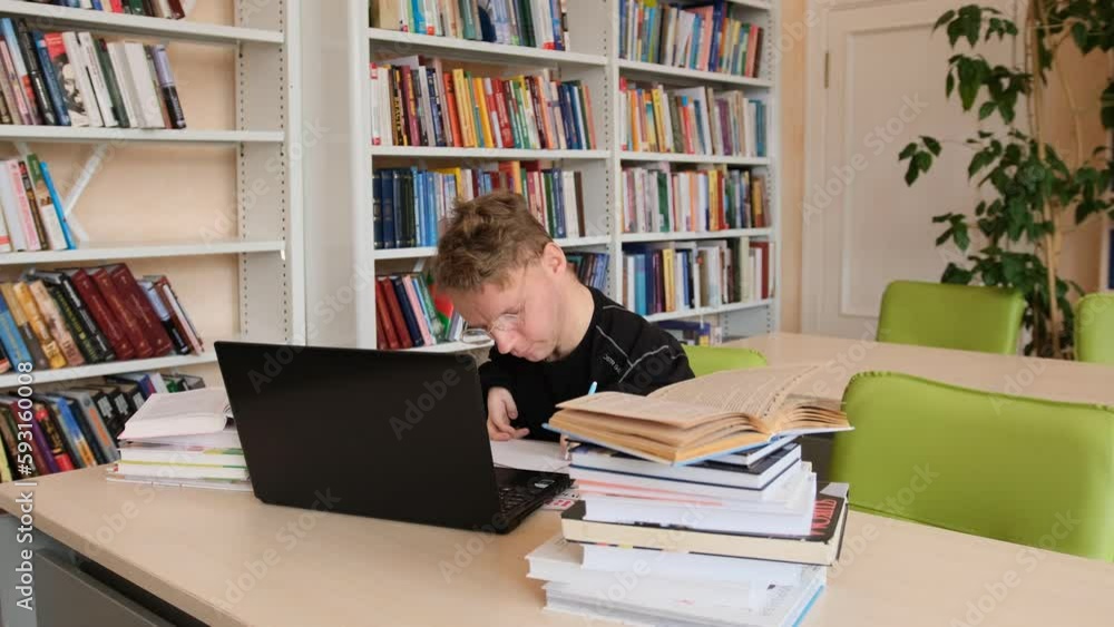 a man with congenital hand pathology in the library. a man with congenital hand pathology in the library.