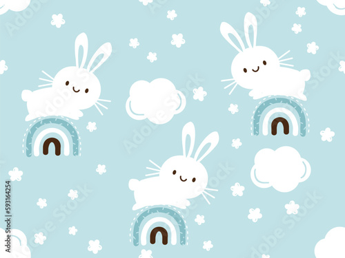 Seamless pattern with bunny rabbit cartoons, rainbows and cute flower on blue background vector illustration.