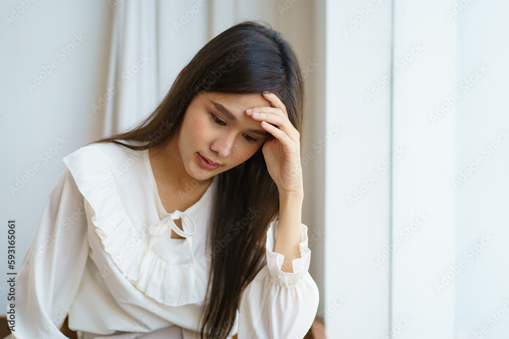 Unhappy - stressful Asian young woman having a depression disease, woman got a headache and touching on her head. Unhappy - stressful Asian young woman having a depression disease, woman got a headache and touching on her head.