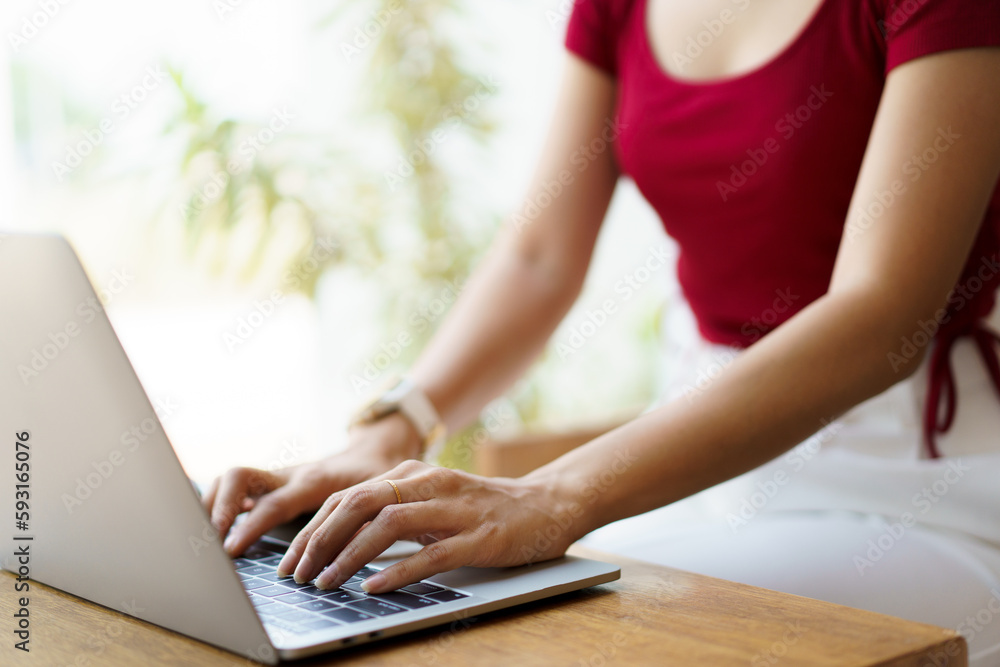 Fototapeta premium Beautiful Asian young woman working in co-working space in coffee shop.