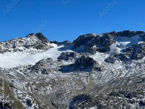 Rocky mountain peaks Piz Sarsura (3176 m) and Grippa Naira (3130 m) in the Albula Alps and above the alpine valley Val Grialetsch, Zernez - Canton of Grisons, Switzerland (Kanton Graubünden, Schweiz) photo