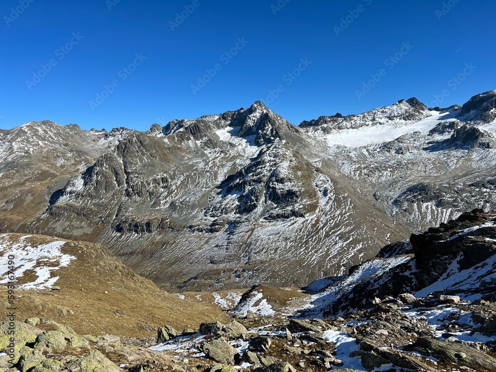 First snow on the rocky mountain peaks Piz Arpschella (3031 m), Piz Sarsura Pitschen (3132 m) and Piz Sarsura (3176 m) in the Albula Alps, Zernez - Canton of Grisons, Switzerland (Schweiz)