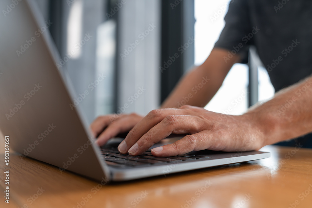 Man hands typing on laptop keyboard in office Man hands typing on laptop keyboard in office