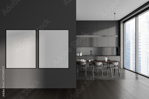 Dark gray kitchen with dining table and posters