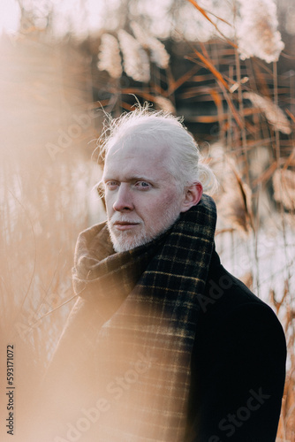 Portraits of an albino man with long hair. Autumn
