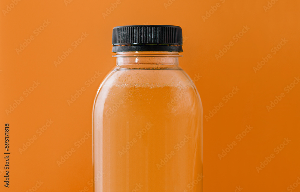 Bottle of fresh orange juice on yellow background Bottle of fresh orange juice on yellow background