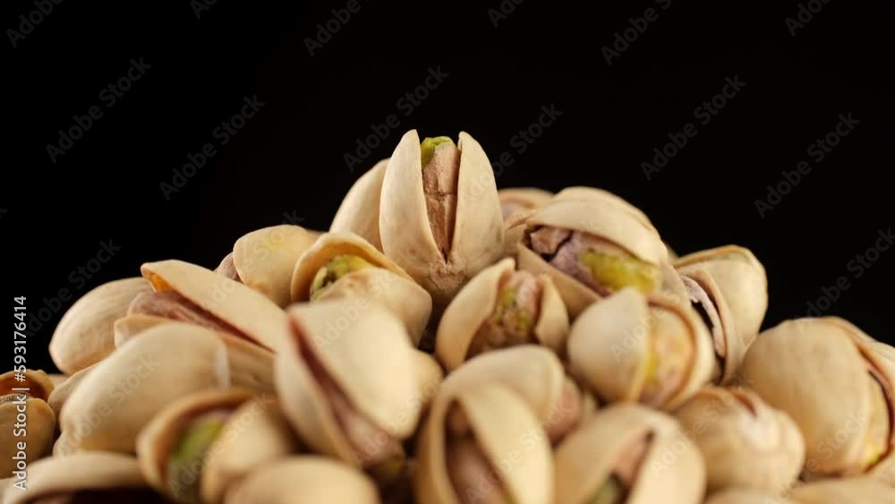 Heap of salted roasted pistachios rotation on black background Heap of salted roasted pistachios rotation on black background
