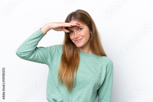 Young caucasian woman isolated on white background looking far away with hand to look something