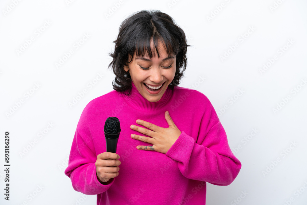Young Argentinian singer woman isolated on white background smiling a lot Young Argentinian singer woman isolated on white background smiling a lot