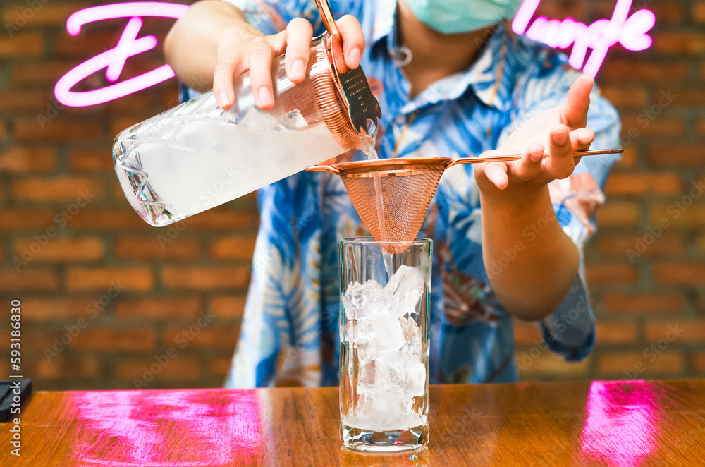 Fototapeta premium bartender Fresh lemonade cocktail with crushed ice, and divers oranges. Summer cold drink concept in luxury bar