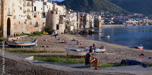 Cefalù, Palermo.Spiaggia del Porto Vecchio con barche e persone
 photo