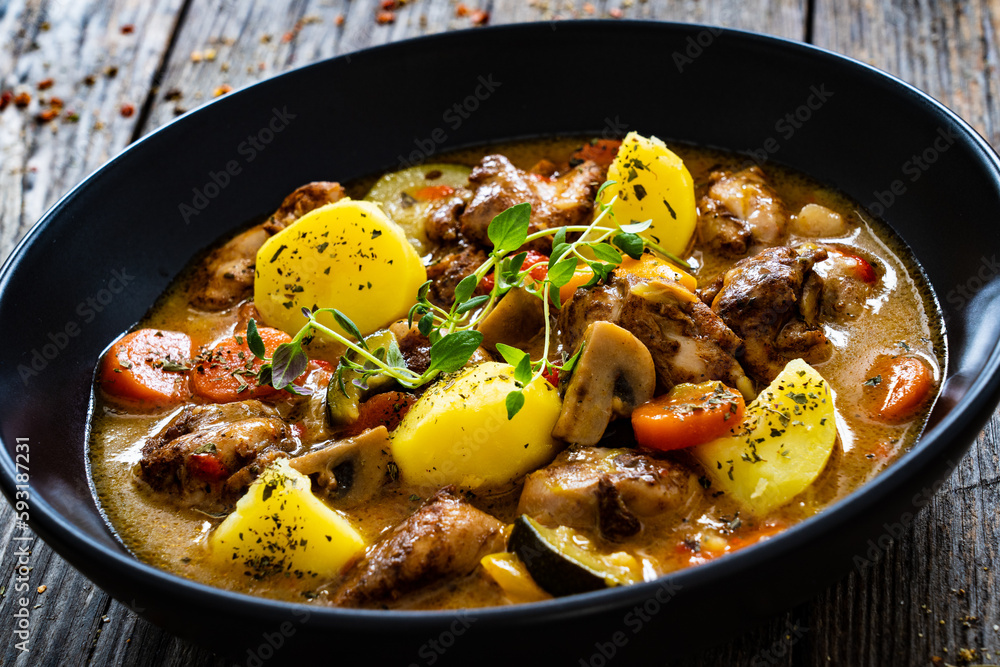 Delicious stew - cooked vegetables with roast meat on wooden table
Delicious stew - cooked vegetables with roast meat on wooden table