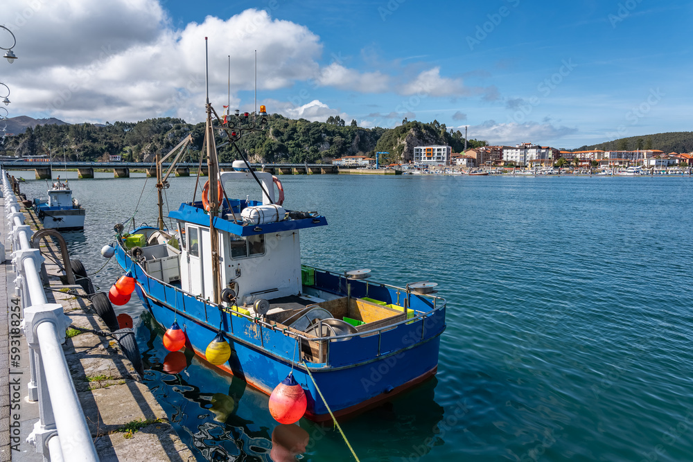 Small fishing boats docked on the promenade of the coastal town of Ribadesella, Asturias.