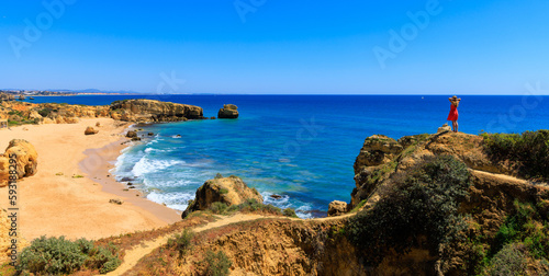 Woman tourist enjoying panoramic view of beautiful algarve beach- travel destination, summer vacation travel concept- Portugal ( praia da Marinha, carvoeiro, benagil)