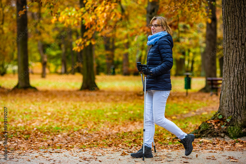 Nordic walking - woman training in city park
Nordic walking - woman training in city park