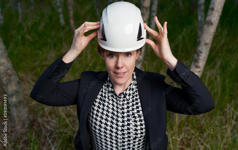 corporate woman lifting her hard hat smiling corporate woman lifting her hard hat smiling