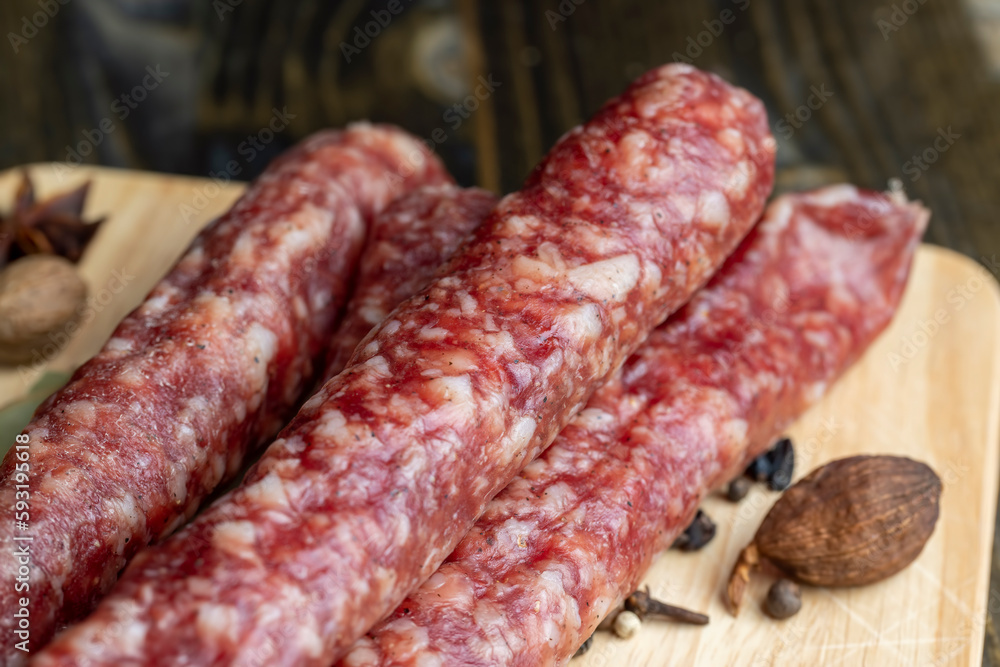 Dried veal sausage during slicing Dried veal sausage during slicing