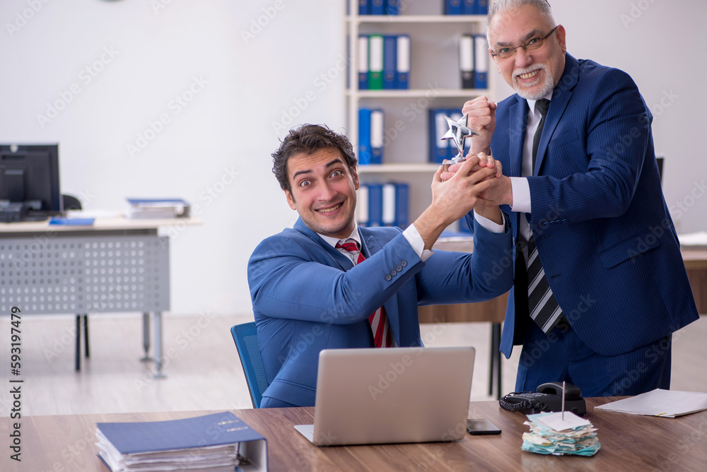 Two male colleagues in employee of the month concept Two male colleagues in employee of the month concept