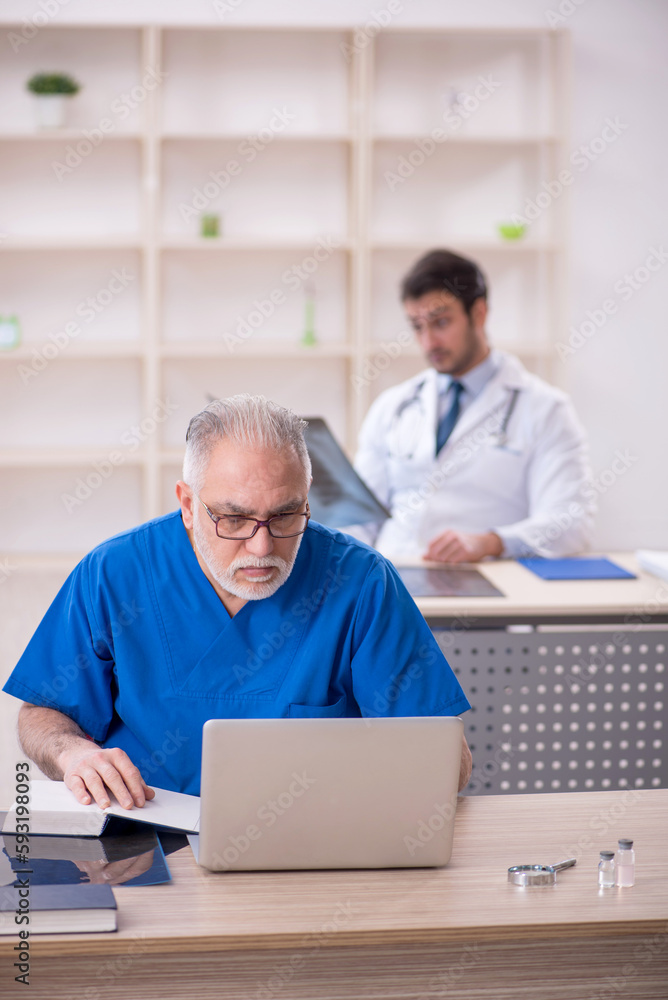 Two male doctors in telemedicine concept Two male doctors in telemedicine concept