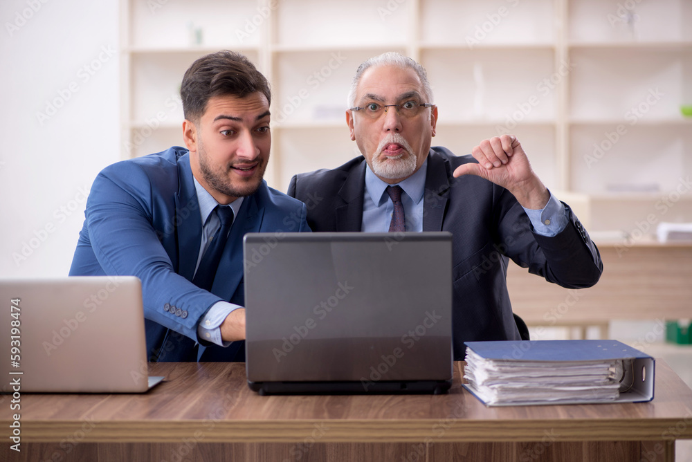 Two male employees working in the office Two male employees working in the office