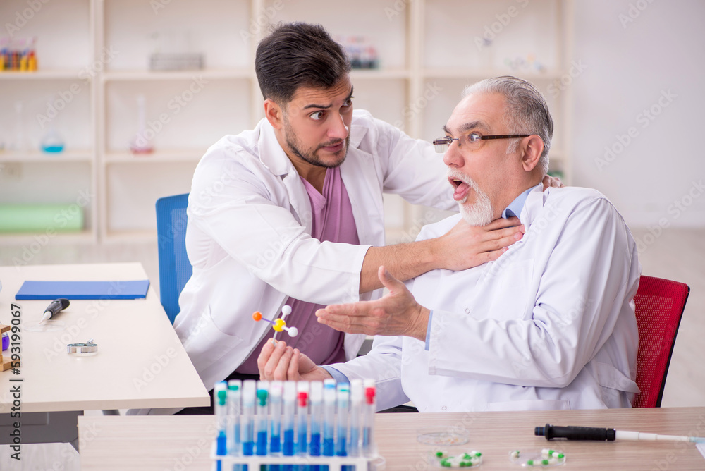 Two male chemists working at the lab Two male chemists working at the lab