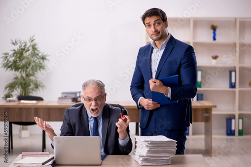 Two male colleagues working in the office