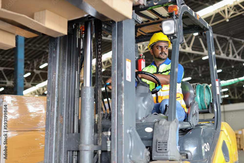 Warehouse workers or forklift driver man with hardhats and reflective jackets in vehicle using walkie talkie radio controlling stock and inventory in retail warehouse logistics, distribution center Warehouse workers or forklift driver man with hardhats and reflective jackets in vehicle using walkie talkie radio controlling stock and inventory in retail warehouse logistics, distribution center