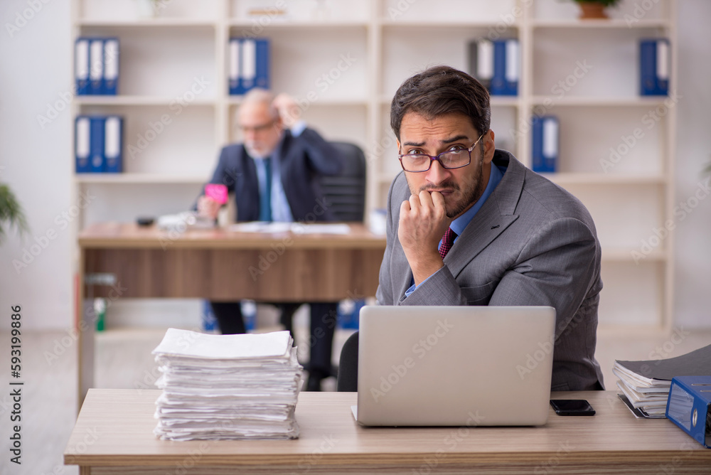 Two male colleagues working in the office Two male colleagues working in the office