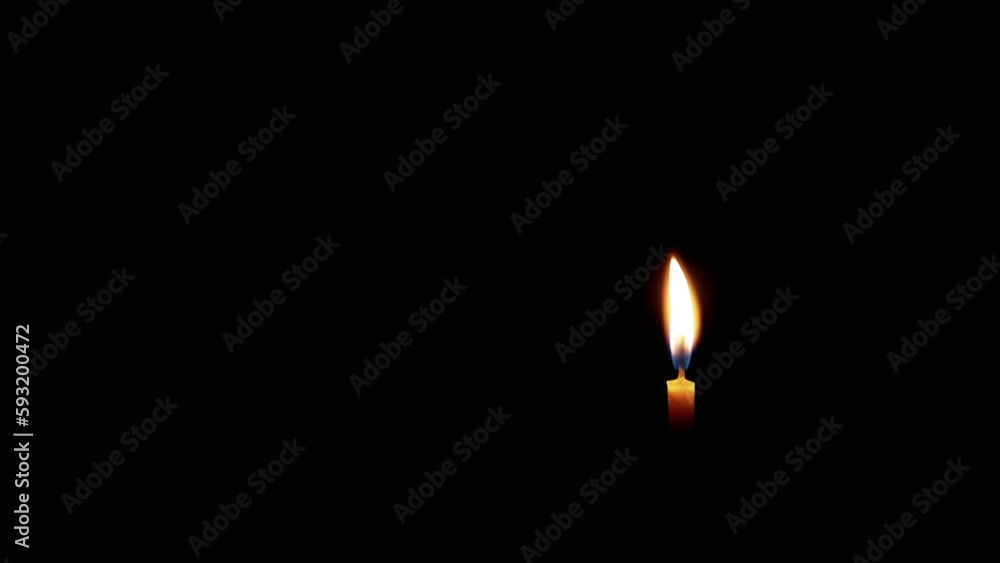 Burning Flame of a Church Candle on Isolated Black Background. Empty space, a place for text. One yellow small thin wax candle in the corner. Fire movement. Concept of memory, grief funeral, sadness. Burning Flame of a Church Candle on Isolated Black Background. Empty space, a place for text. One yellow small thin wax candle in the corner. Fire movement. Concept of memory, grief funeral, sadness.