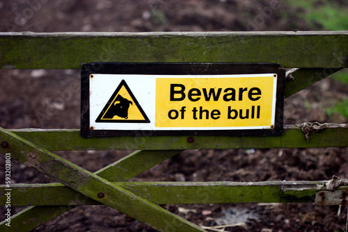 Sign 'beware of the bull' on a field gate