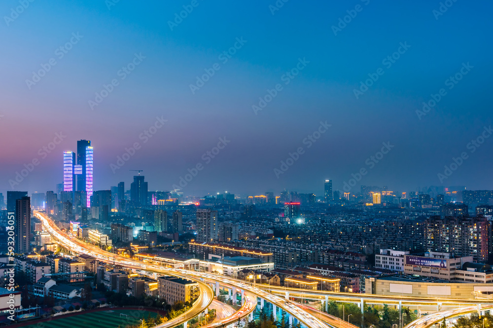 Fototapeta premium Night view of Saihong Bridge and city skyline in Nanjing, Jiangsu, China