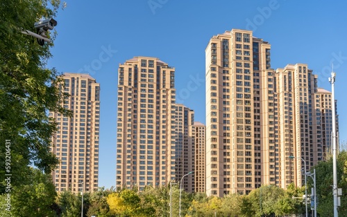 Modern residential complex with tall houses against the blue sky