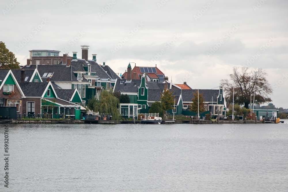 Windmills and wooden houses in the Zaanse Schans, Zaanstad, Netherlands.