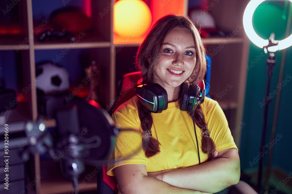 Young blonde woman streamer smiling confident sitting with arms crossed gesture at gaming room Young blonde woman streamer smiling confident sitting with arms crossed gesture at gaming room