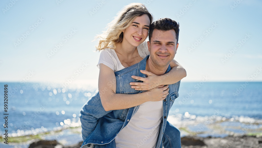 Man and woman couple smiling confident standing on back at seaside Man and woman couple smiling confident standing on back at seaside