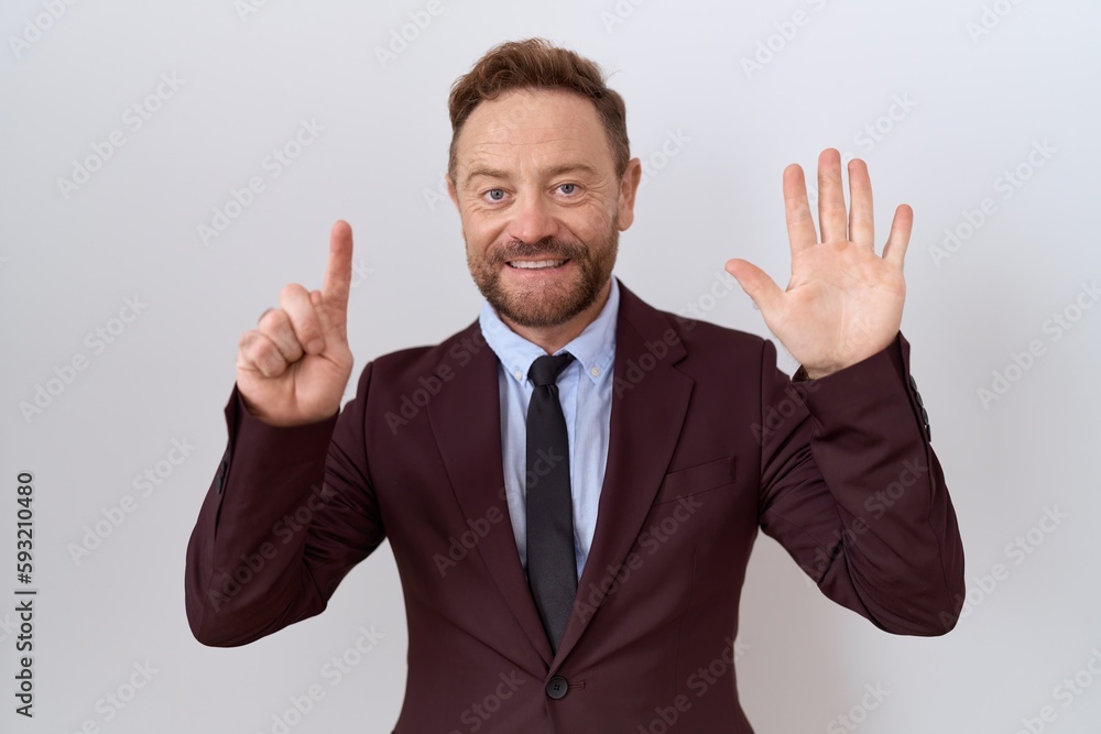 Middle age business man with beard wearing suit and tie showing and pointing up with fingers number six while smiling confident and happy. Middle age business man with beard wearing suit and tie showing and pointing up with fingers number six while smiling confident and happy.