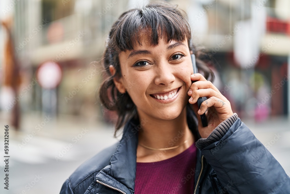 Young beautiful hispanic woman smiling confident talking on the smartphone at street Young beautiful hispanic woman smiling confident talking on the smartphone at street