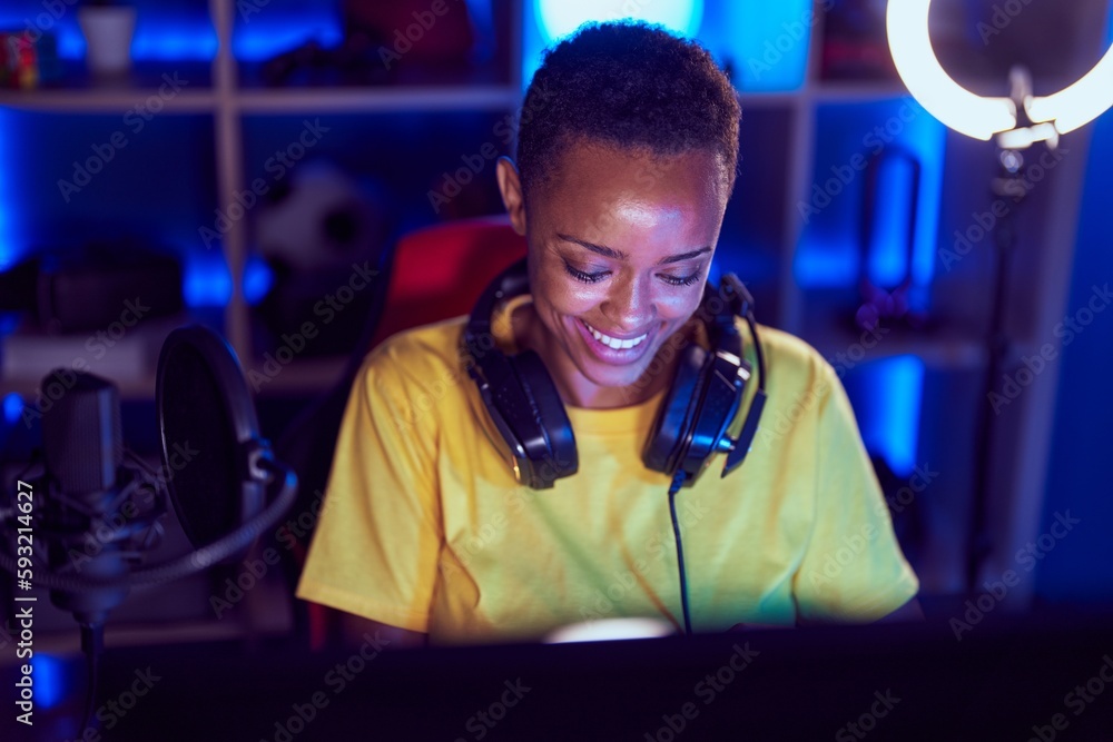 African american woman streamer smiling confident sitting on table at gaming room African american woman streamer smiling confident sitting on table at gaming room