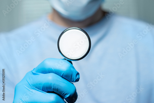 Close-up of male doctor using stethoscope , focus on stethoscope