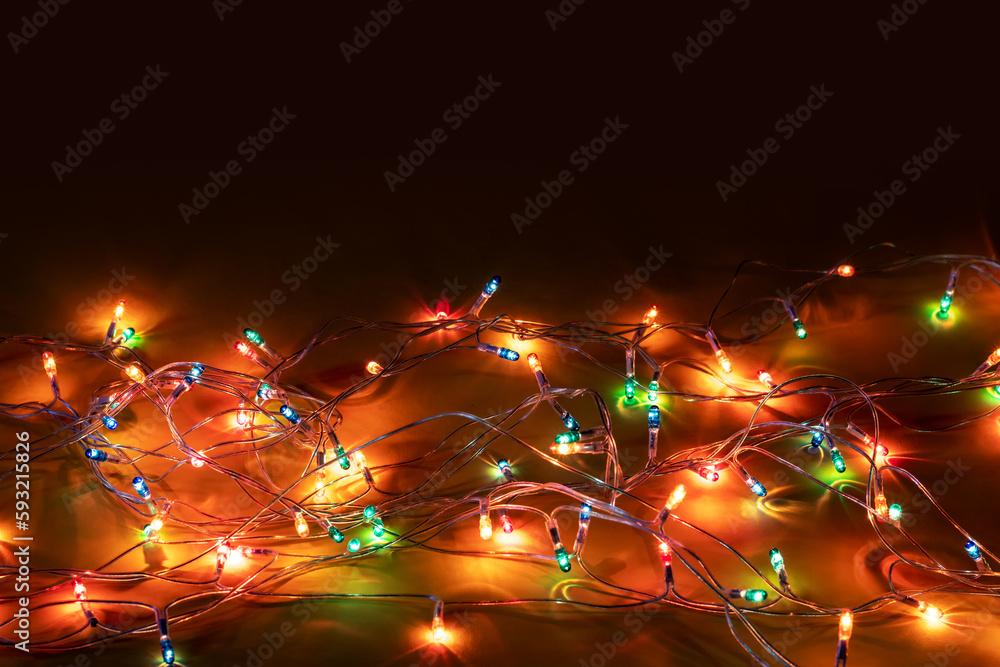Christmas garland lights on dark background copy space