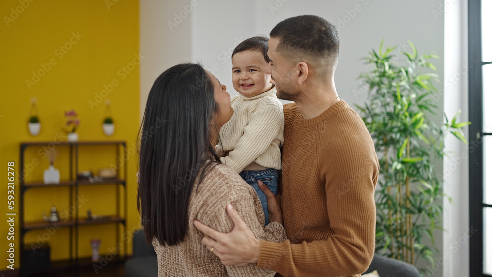 Couple and son hugging each other standing at home Couple and son hugging each other standing at home