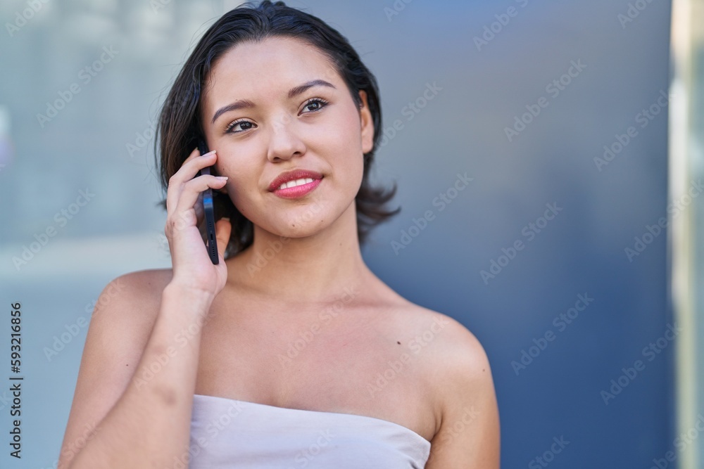 Young hispanic woman smiling confident talking on the smartphone at street Young hispanic woman smiling confident talking on the smartphone at street