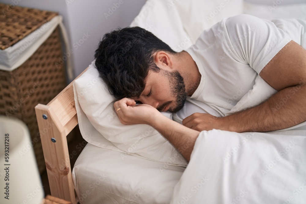 Young hispanic man lying on bed sleeping at bedroom Young hispanic man lying on bed sleeping at bedroom