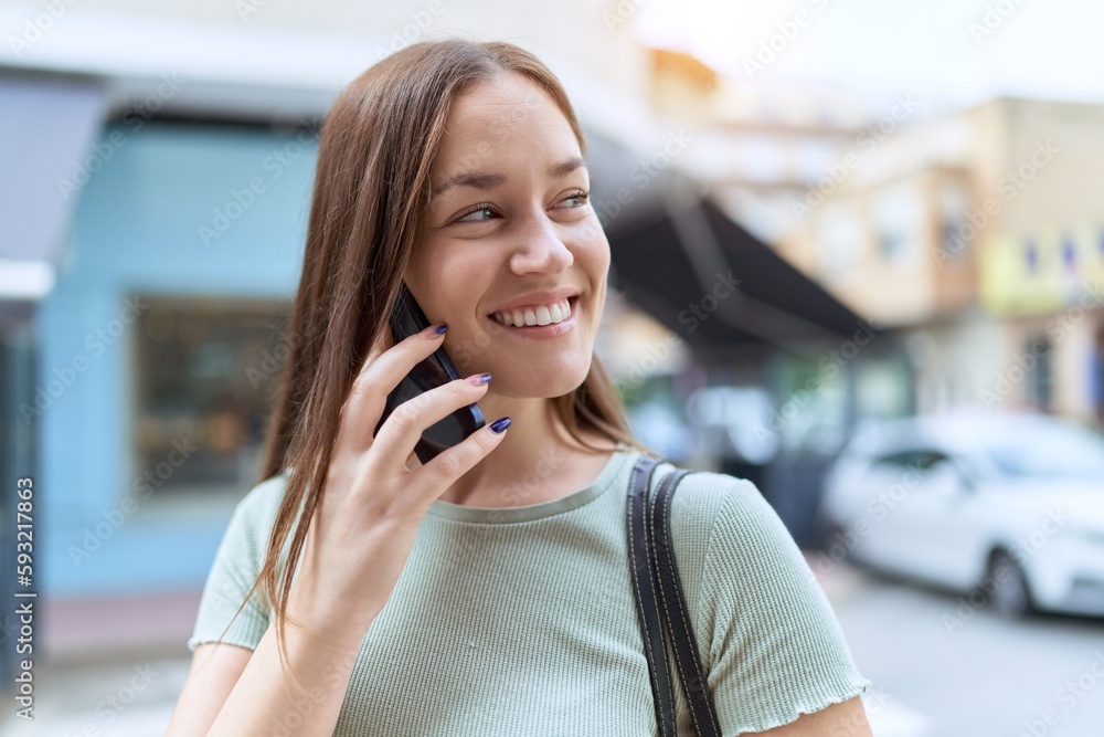 Young beautiful woman smiling confident talking on the smartphone at street Young beautiful woman smiling confident talking on the smartphone at street