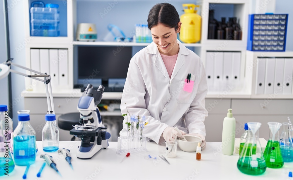 Young woman wearing scientist uniform working at laboratory Young woman wearing scientist uniform working at laboratory