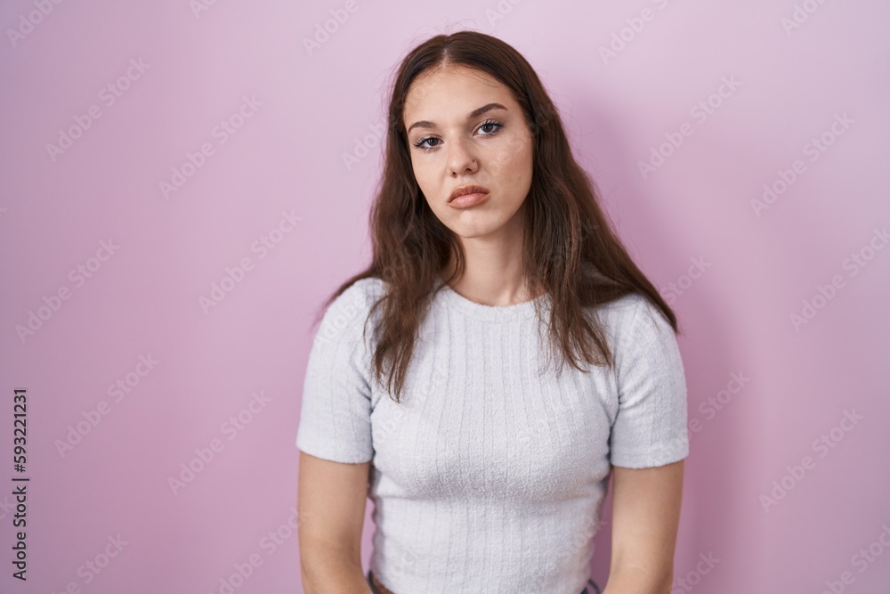 Young hispanic girl standing over pink background looking sleepy and tired, exhausted for fatigue and hangover, lazy eyes in the morning. Young hispanic girl standing over pink background looking sleepy and tired, exhausted for fatigue and hangover, lazy eyes in the morning.