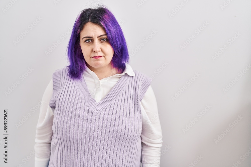 Fototapeta premium Plus size woman wit purple hair standing over white background skeptic and nervous, frowning upset because of problem. negative person.