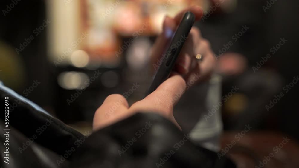 Woman scrolling through mesages on the phone Woman scrolling through mesages on the phone