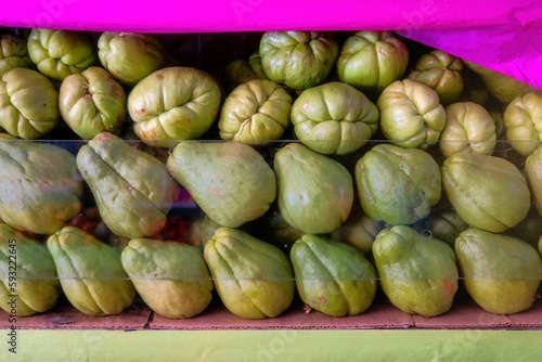 Pile of Chayote (Sechium edule) behind a glass shelf in a store